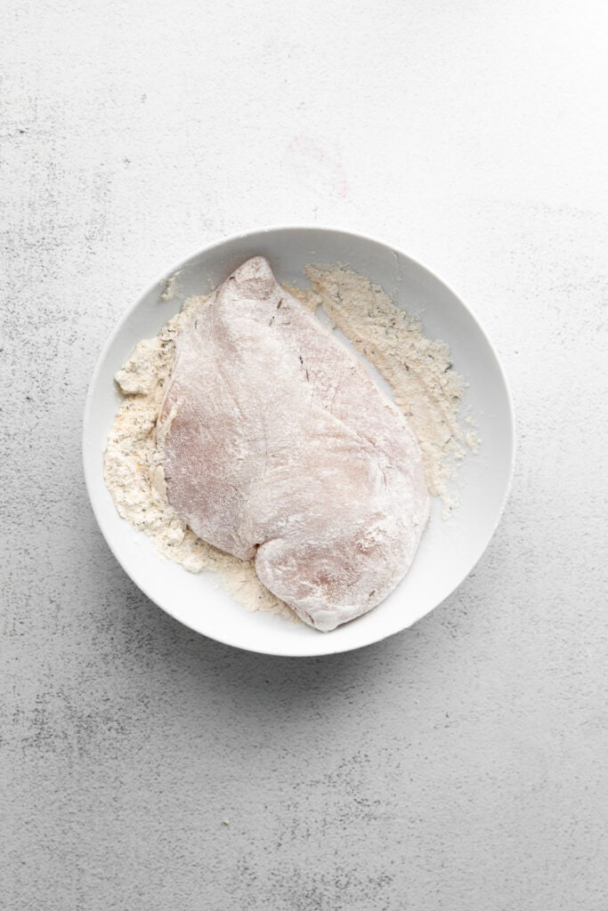 Homemade chicken Alfredo is easier to make than you think. You'll love this silky, flavorful Alfredo sauce paired with pan-seared chicken and fettuccini! chicken breast in bowl