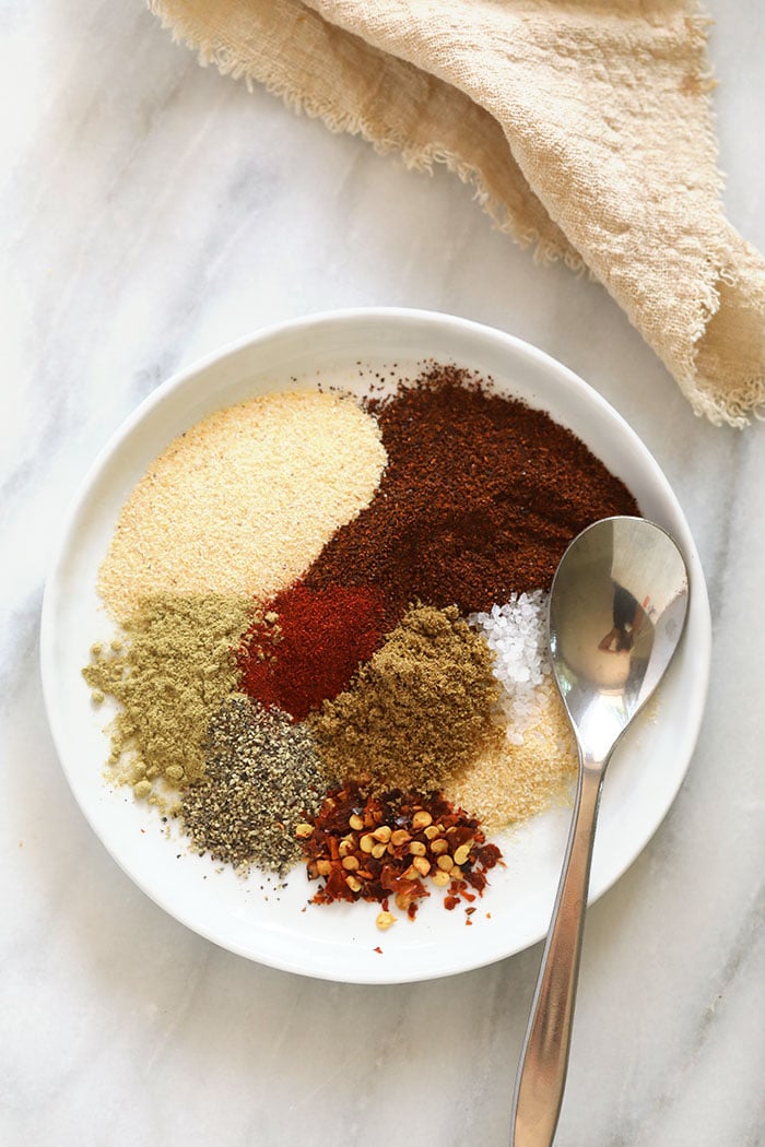 Make your own Homemade Taco Seasoning with just 9 ingredients you likely already have in your spice cupboard, and you'll be on your way to the most flavorful meat or veggie tacos in no time. homemade taco seasoning ingredients on a plate