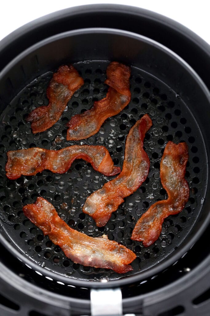Looking for a quick and easy air fryer bacon tutorial? In this post, we'll teach you how to cook bacon in the air fryer in just a few steps! cooked bacon in air fryer