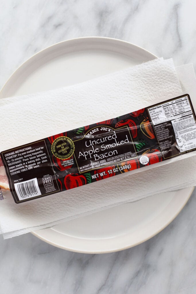 Trader Joes uncooked bacon wrapped on a plate.