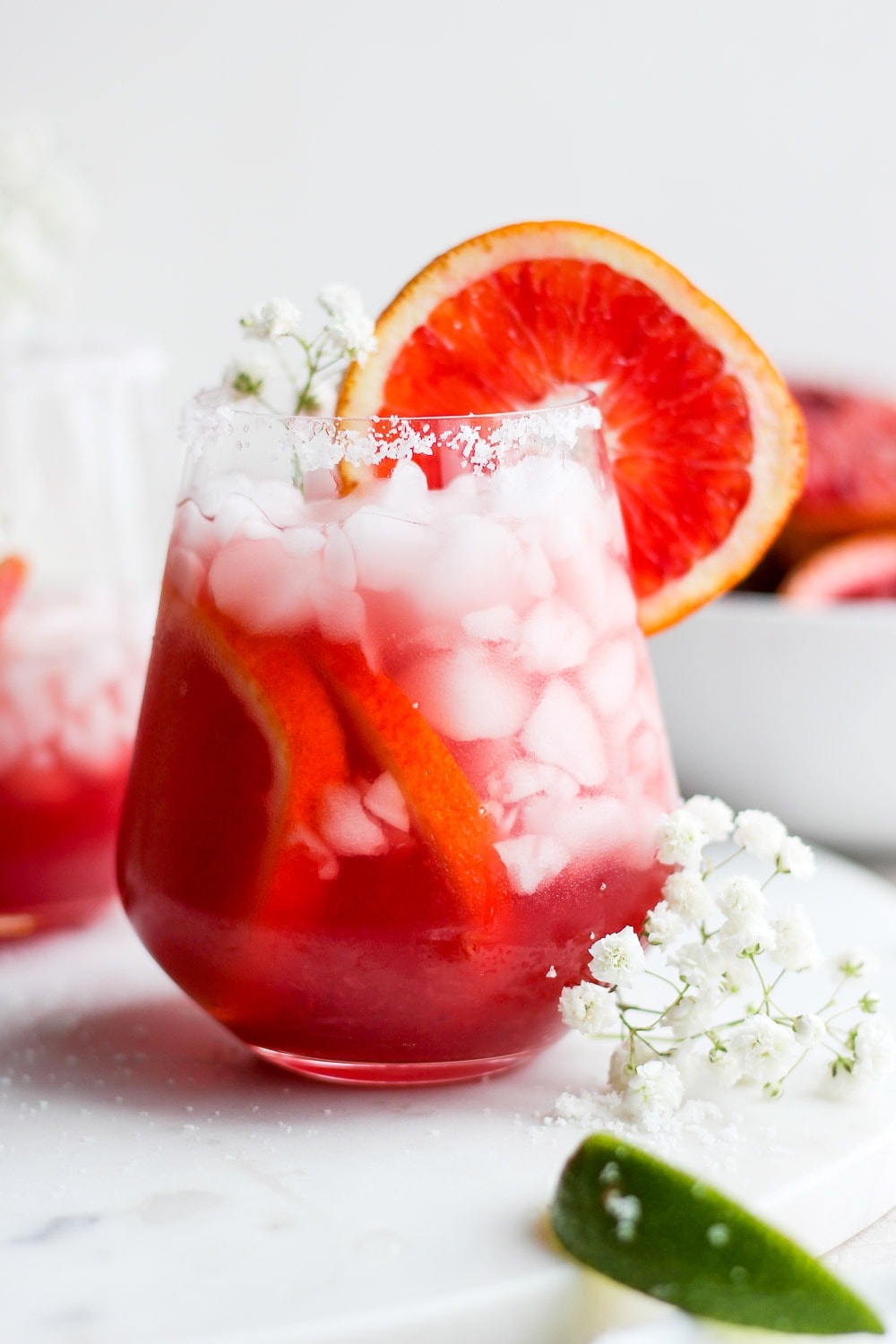 Take your margaritas up a notch! These refreshing blood orange margaritas are easy to mix up for two or mixed up in a pitcher margaritas for a crowd. All you need is fresh blood orange juice, simple syrup, lime juice, and tequila! Blood Orange Margarita in a glass