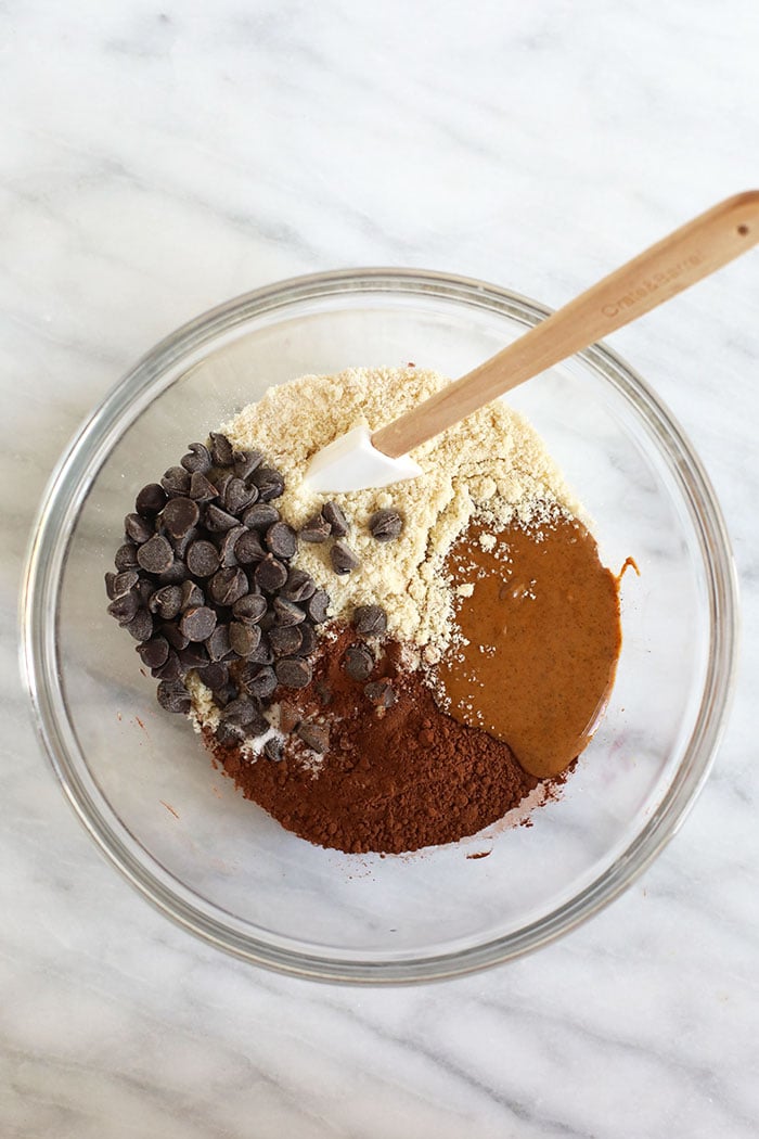 We made you the Fudgiest Paleo Brownies of your dreams! Made with a combination of coconut flour and almond flour, these healthy brownies taste like the real deal, but are actually grain-free, dairy-free, and gluten-free! bowl of ingredients