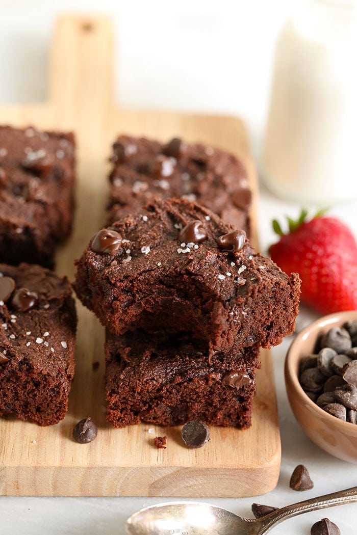 Looking for a healthy brownie recipe that doesn't taste healthy? These fudgy brownies are grain-free and use minimal added oil! paleo brownie with bite taken out of it