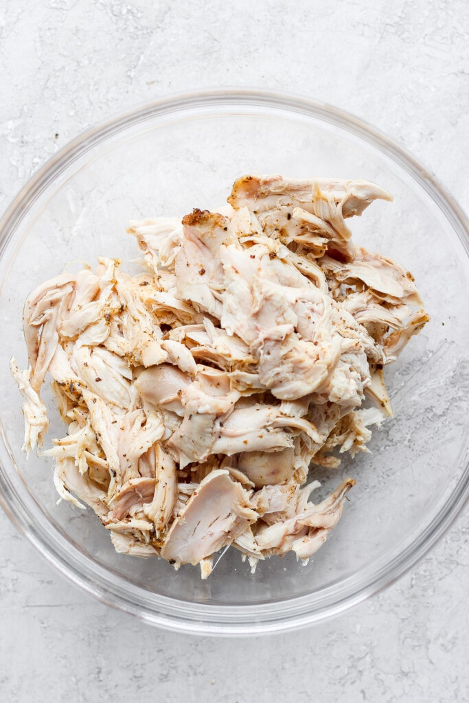 Plain shredded chicken in a bowl.