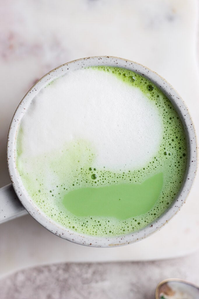 Ready to learn how to make a matcha latte? Matcha green tea lattes are a great substitute for an espresso latte. Keep reading to learn how to perfect this warm, drink! matcha latte in mug