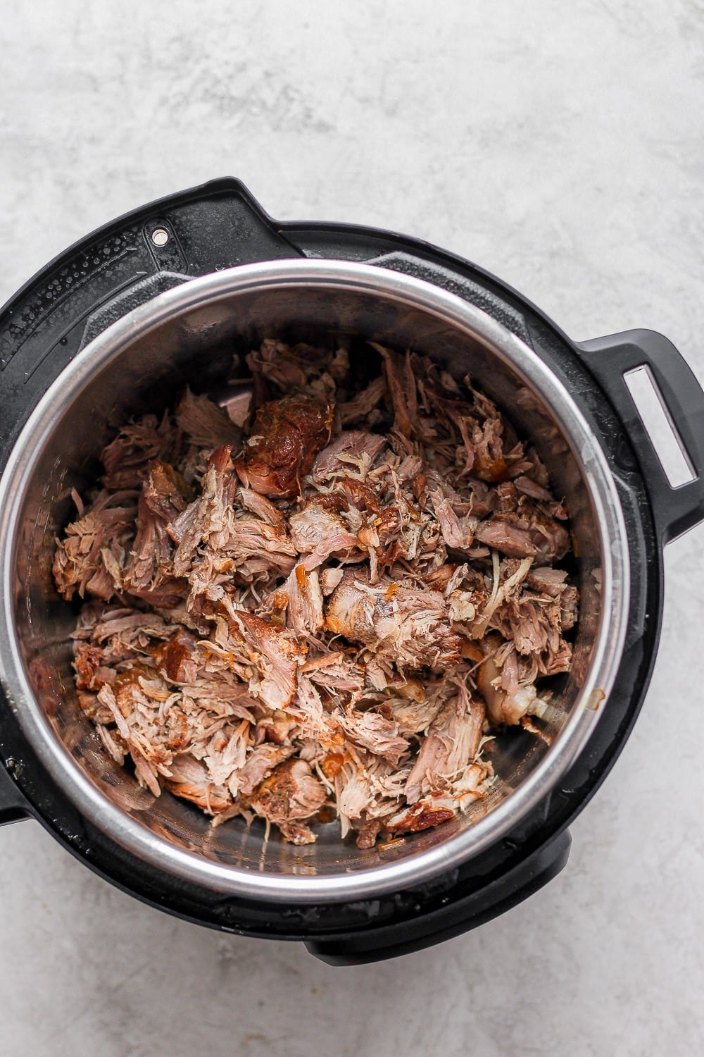 The most tender and juicy Instant Pot Pulled Pork made with a delicious dry rub and your favorite bbq sauce! cooked shredded pulled pork in instant pot