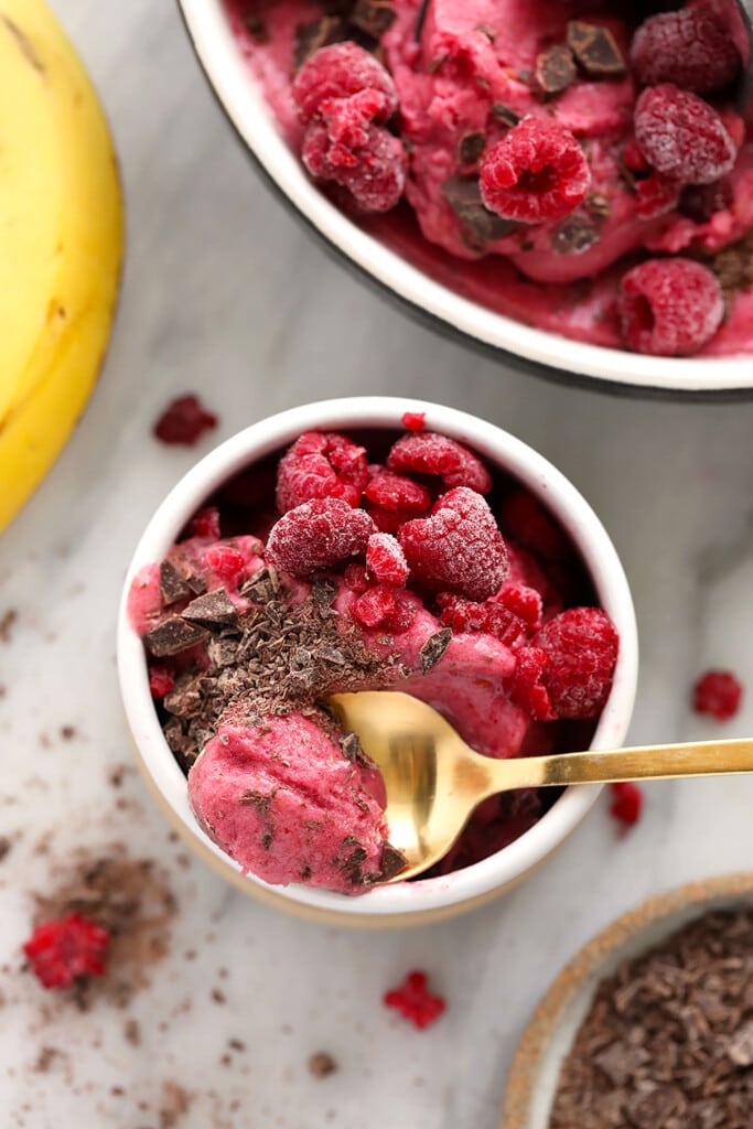 This 5-ingredient Raspberry Chocolate Chunk Nice Cream boasts the same creamy deliciousness of traditional raspberry ice cream, but without all those fillers. raspberry chocolate chunk banana nice cream in a bowl, ready to be enjoyed