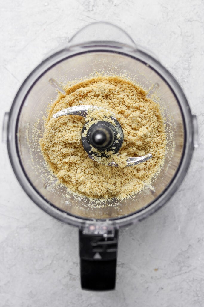 This 5-Ingredient Vegan Parmesan Cheese is a delicious vegan alternative to traditional grated parmesan. Make a batch and sprinkle onto any savory dish your heart desires. vegan parmesan cheese blended to perfection in a food processor