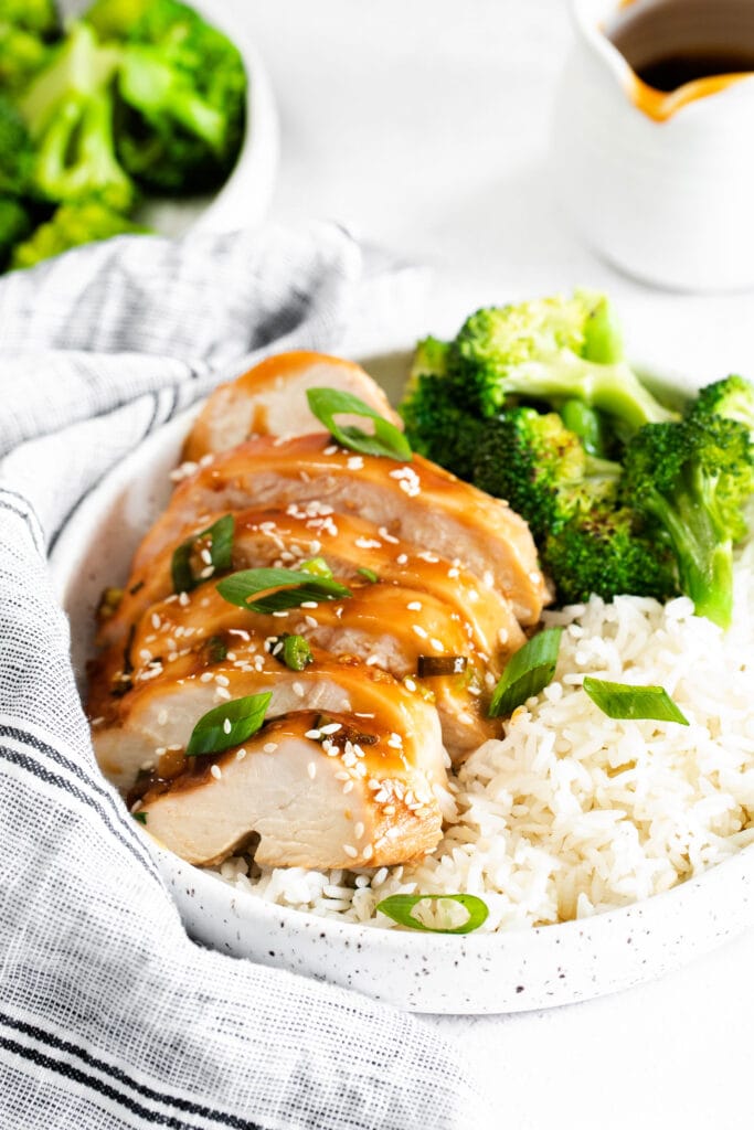 When in doubt, make this easy Baked Teriyaki Chicken Breast. The chicken is marinated in an easy homemade teriyaki chicken marinade and then baked in a casserole dish until tender. sliced teriyaki chicken with white rice and broccoli in bowl