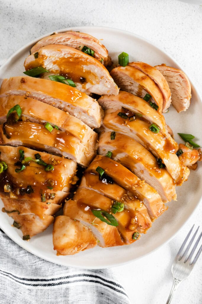 When in doubt, make this easy Baked Teriyaki Chicken Breast. The chicken is marinated in an easy homemade teriyaki chicken marinade and then baked in a casserole dish until tender. sliced teriyaki chicken on plate