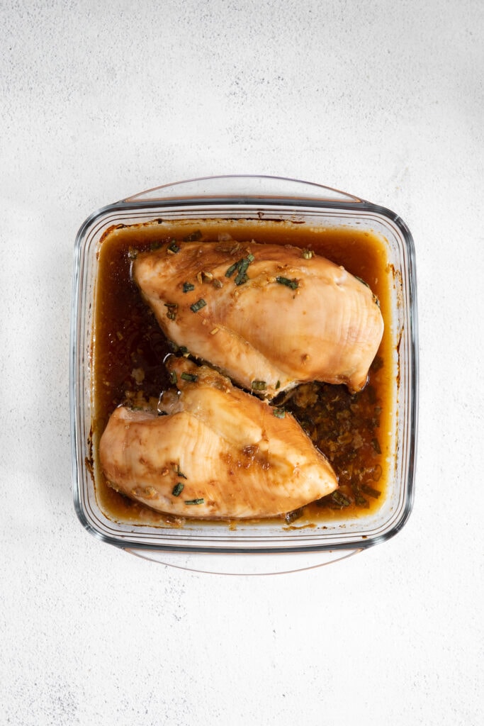 When in doubt, make this easy Baked Teriyaki Chicken Breast. The chicken is marinated in an easy homemade teriyaki chicken marinade and then baked in a casserole dish until tender. cooked chicken breast in casserole dish with sauce