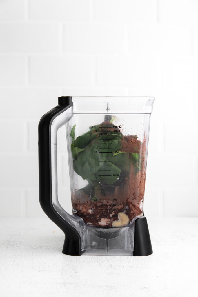 This Chocolate Peanut Butter Banana Smoothie is packed with protein and even has a full serving of greens in it. The best part is, it's healthy and tastes exactly like a peanut butter cup! smoothie ingredients in blender