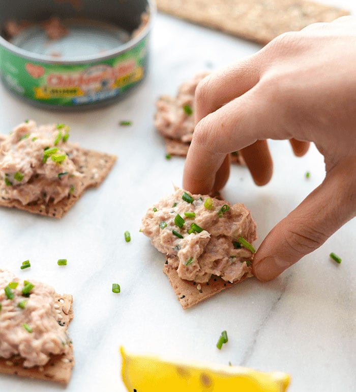 Are you looking for a tuna salad made without mayo? You hit the jackpot! This quick, 4-ingredient Healthy Tuna Salad Recipe only takes 5 minutes to make, and is packed with 34 grams of protein. The perfect post-workout snack! healthy tuna salad on a cracker