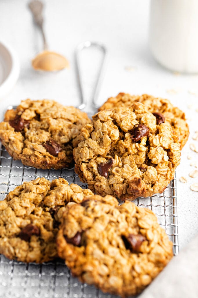 Perfectly chewy on the inside and crispy on the outside peanut butter chocolate chip cookies. These are seriously the best healthy peanut butter oatmeal cookies you've ever had! oatmeal cookies on wire rack