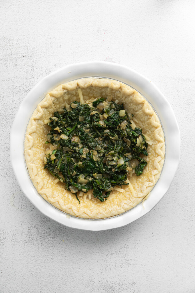 Spinach, onions, and garlic in a quiche crust.