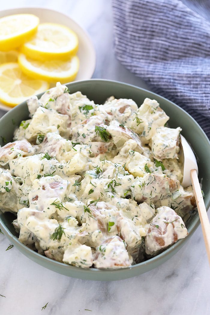This vegan potato salad is light, bright, and delicious! Not only is this potato salad the perfect summer side, but it's also so easy to make. A bowl of vegan potato salad ready to be served