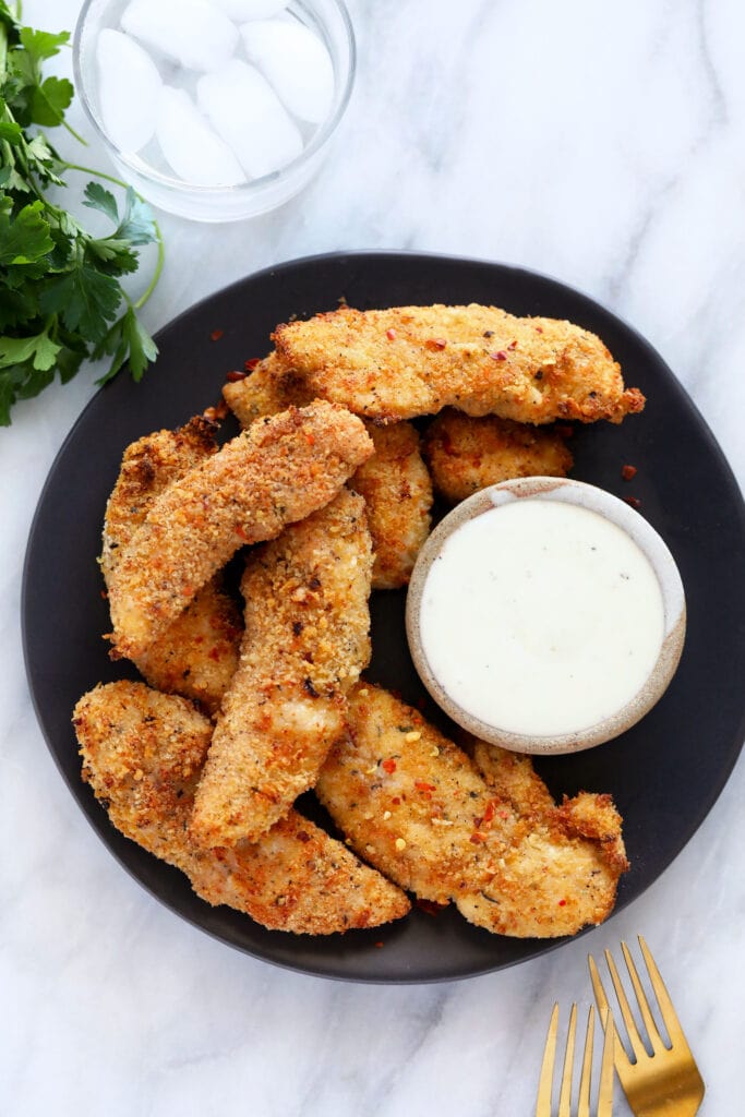 Air Fryer Chicken Tenders come out super tender on the inside and crispy on the outside. You will love this 30-Minute meal! chicken tenders on plate with ranch