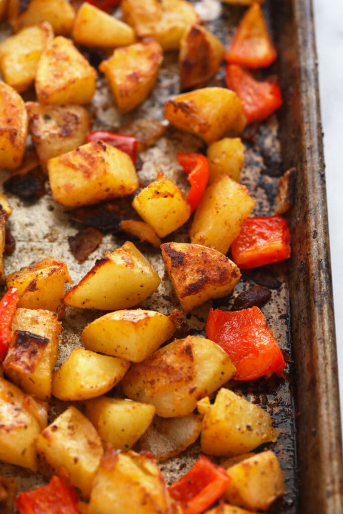 These are the best breakfast potatoes you will ever eat. Perfectly cooked on the inside and crunchy on the outside. Make a big batch of breakfast potatoes and enjoy! breakfast potatoes on a baking sheet looking crispy and delicious