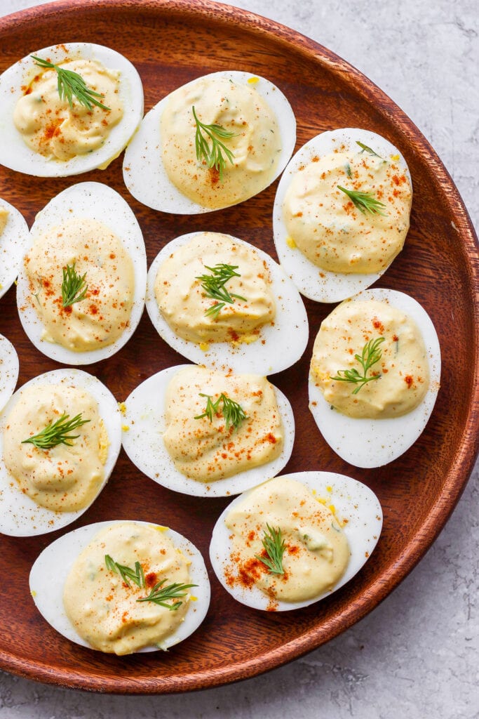 These easy deviled eggs are seriously easy to make with simple ingredients and flavor you'll love. Make a batch of these delicious deviled eggs today! easy deviled eggs on a plate, ready to be served
