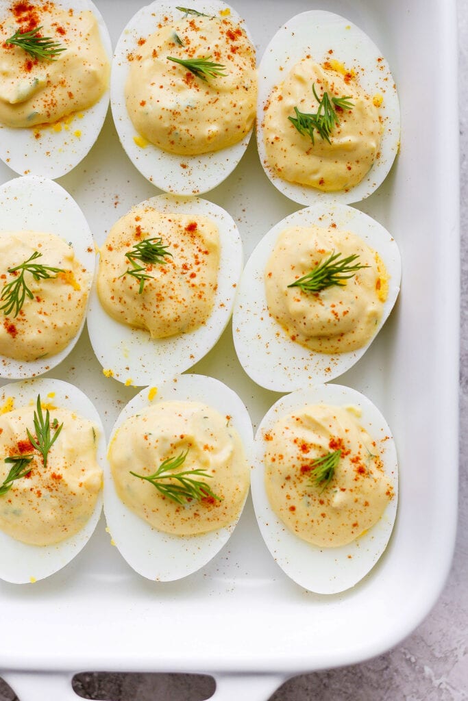 These easy deviled eggs are seriously easy to make with simple ingredients and flavor you'll love. Make a batch of these delicious deviled eggs today! easy deviled eggs in a serving dish