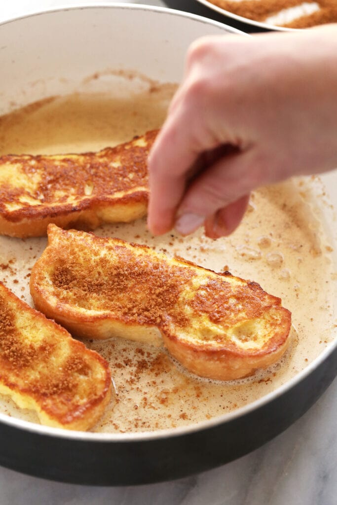 French Toast Sticks are an easy, kid-friendly breakfast recipe made with sliced brioche bread, egg, milk, and a cinnamon-sugar topping. sprinkling on cinnamon sugar