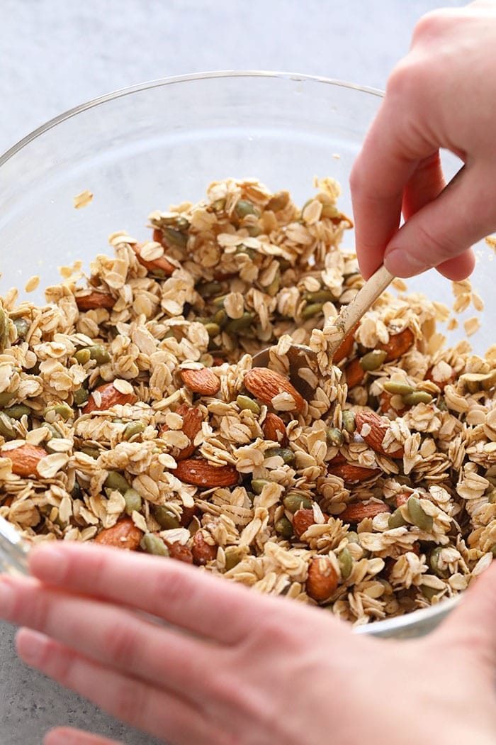 Make a batch of this healthy granola for quick access to a healthy crunch all week long! Store this healthy granola in an airtight container for a healthy breakfast option with a big crunch. Top your favorite breakfast smoothies, yogurt parfaits, or chia seed pudding with this healthy granola. Mixing all the ingredients for healthy granola in a bowls