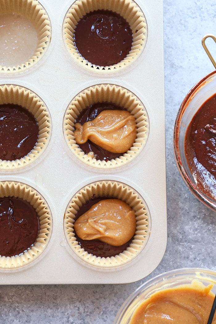 Healthy peanut butter cups made with just 5 real-food ingredients. These peanut butter cups are truly irresistible and the best on the internet! melted Chocolate and peanut butter in cups