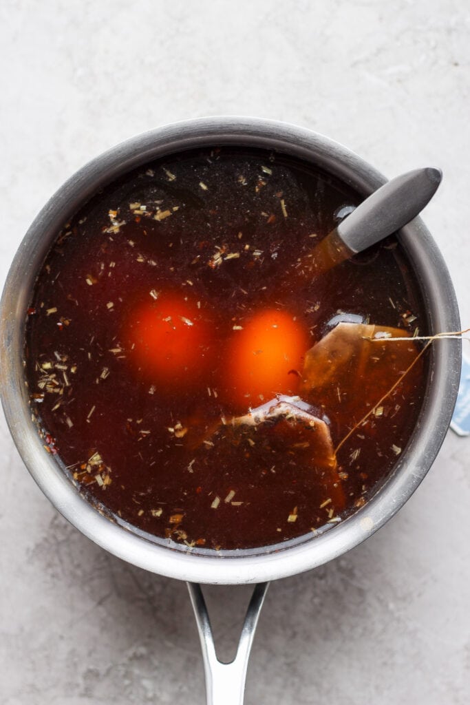 Marinating ramen eggs in a black tea mixture.