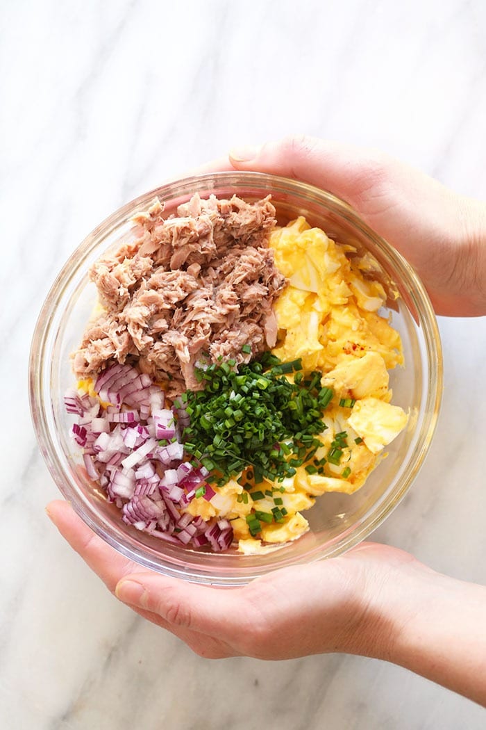 This Tuna Egg Salad blends the flavors you love from tuna salad with egg salad for a satisfying and protein-packed lunch! Filled with a short list of real ingredients, this tuna egg salad recipe can't be beat. Lunch is served! tuna egg salad ingredients in a bowl