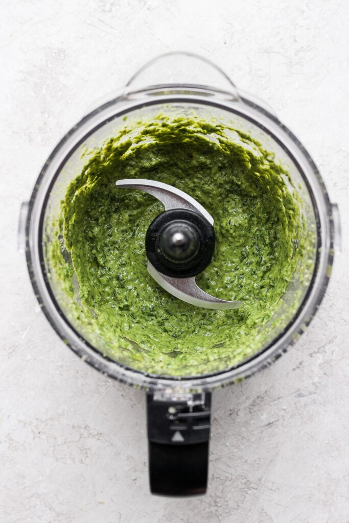 Make this simple vegan pesto recipe with fresh basil, olive oil, lemon juice, and a homemade vegan parmesan cheese. pesto in food processor