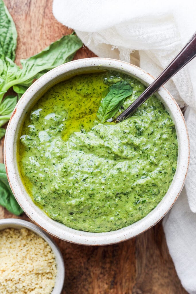 Make this simple vegan pesto recipe with fresh basil, olive oil, lemon juice, and a homemade vegan parmesan cheese. pesto in bowl