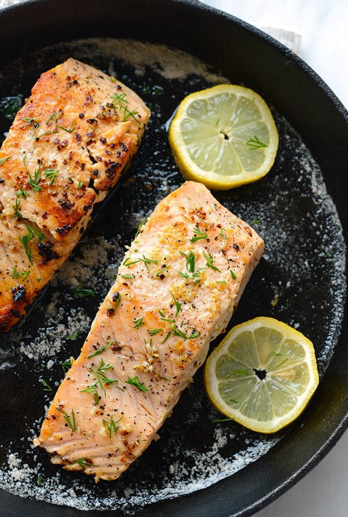 Make this Lemon Butter Pan Seared Salmon in 30 minutes or less using fresh salmon, butter, garlic, and lemon! pan seared salmon with lemon in cast iron pan