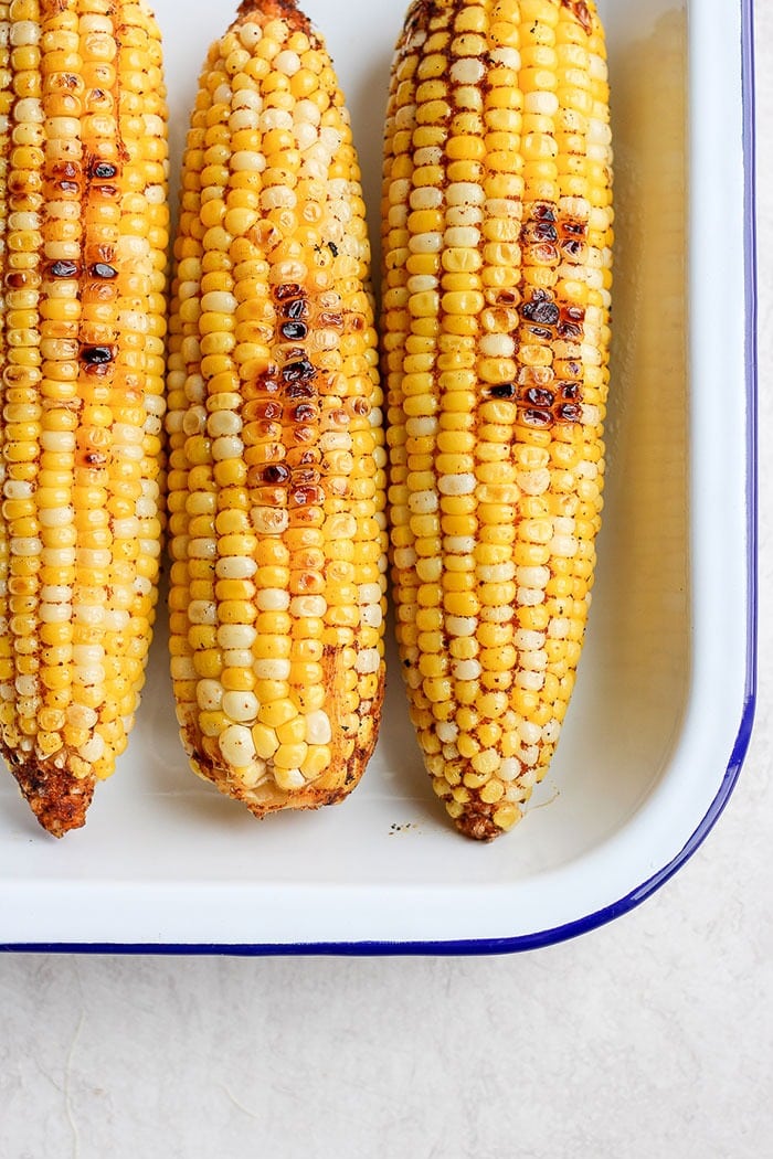 Take dinner up a notch and add this Mexican Street Corn Salad to the menu! This delicious healthy side dish is made with grilled corn, fresh veggies, and the most delicious cotija yogurt sauce. Drop everything you're doing and make this Mexican Street Corn Salad today! Grilled Mexican corn with chili powder