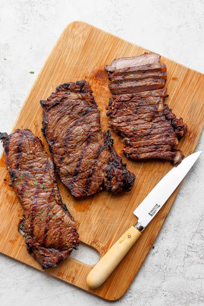 sliced cooked steak on cutting board