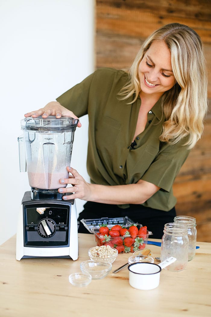 Start your day off right with this protein-packed healthy breakfast smoothie. Filled with fruit, oats, protein powder, almond milk and a little hit of peanut butter, this breakfast smoothie of all breakfast smoothies will keep you feeling satisfied til lunch. healthy breakfast smoothie being made in the Vitamix
