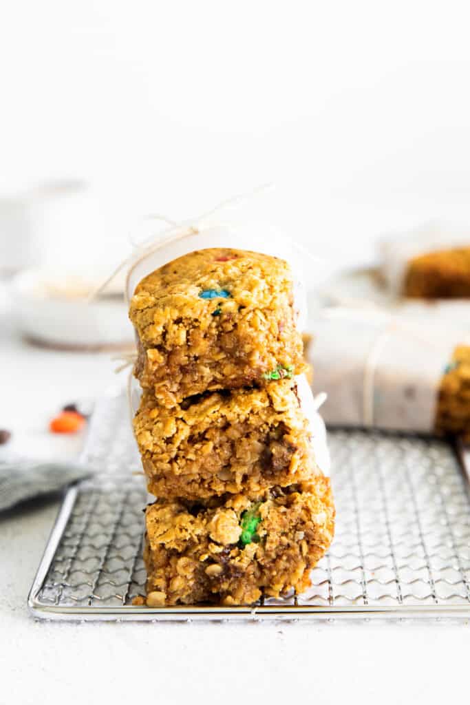 These monster cookie bars are easy to whip up and so yummy! They're made with rolled oats, peanut butter, chocolate chips, and m&ms. monster bars stacked