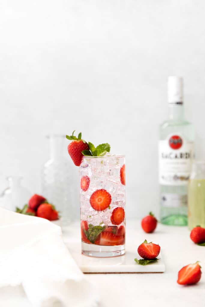 Fancy up your rum cocktail recipes with this strawberry mojito recipe! It's made with strawberries, mint, white rum, club soda, and a homemade mint simple syrup. strawberry mojito in glass