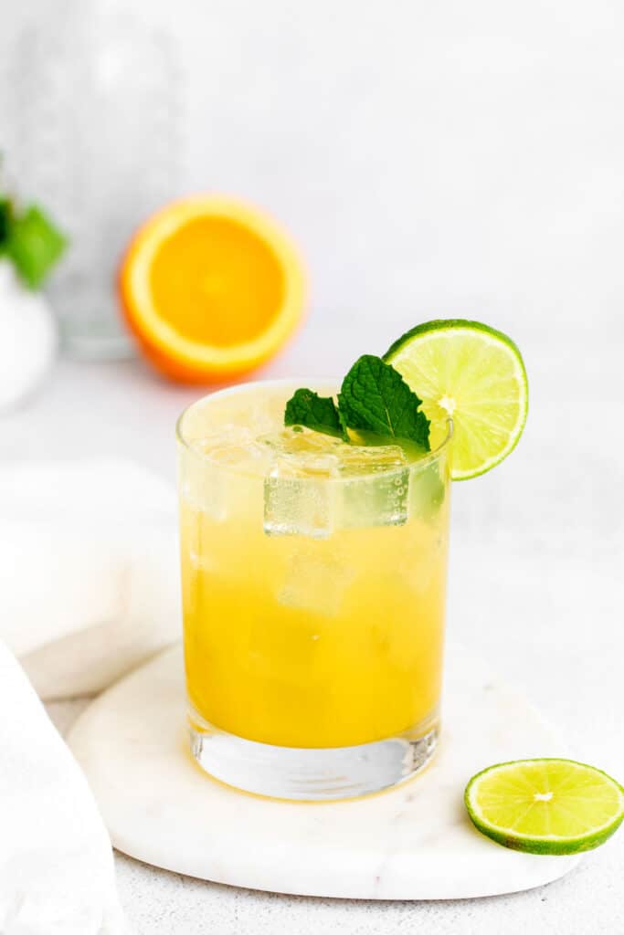 A refreshing virgin margarita recipe that's made with lime juice, orange juice, a little agave nectar, and sparkling water. margarita with mint and a lime wedge