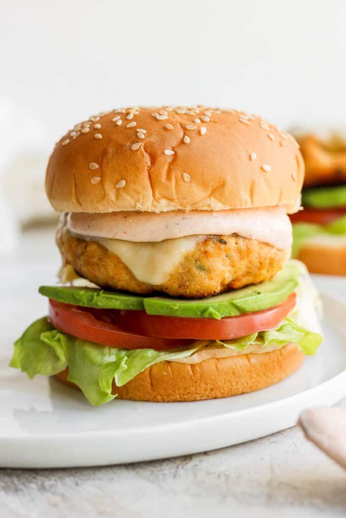 If you are looking for a staple chicken burger recipe, this is it! These ground chicken burgers are so flavorful and moist and topped with our secret burger sauce. chicken burger and sauce on bun