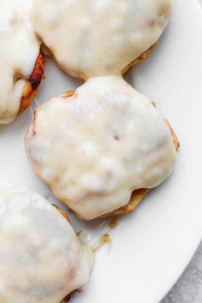 If you are looking for a staple chicken burger recipe, this is it! These ground chicken burgers are so flavorful and moist and topped with our secret burger sauce. melted Swiss cheese on chicken burger