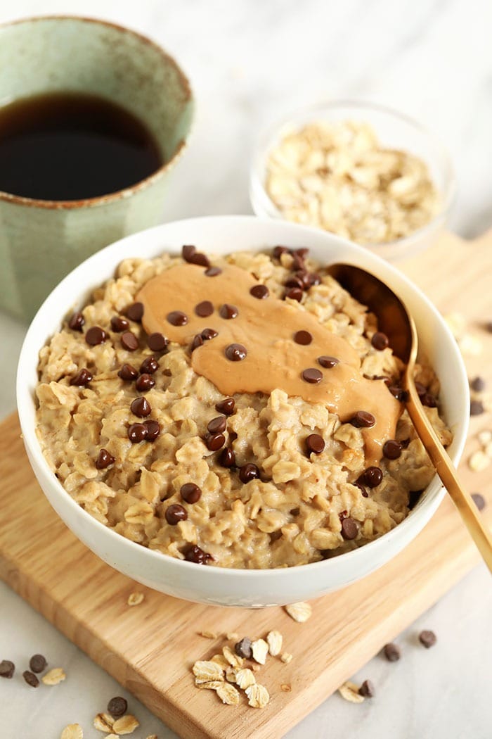 Make our 2-Minute Microwave Oatmeal! These oats taste exactly like cookie dough and they have 5g fiber and 7g protein per serving. oatmeal with cashew butter and chocolate chips in bowl