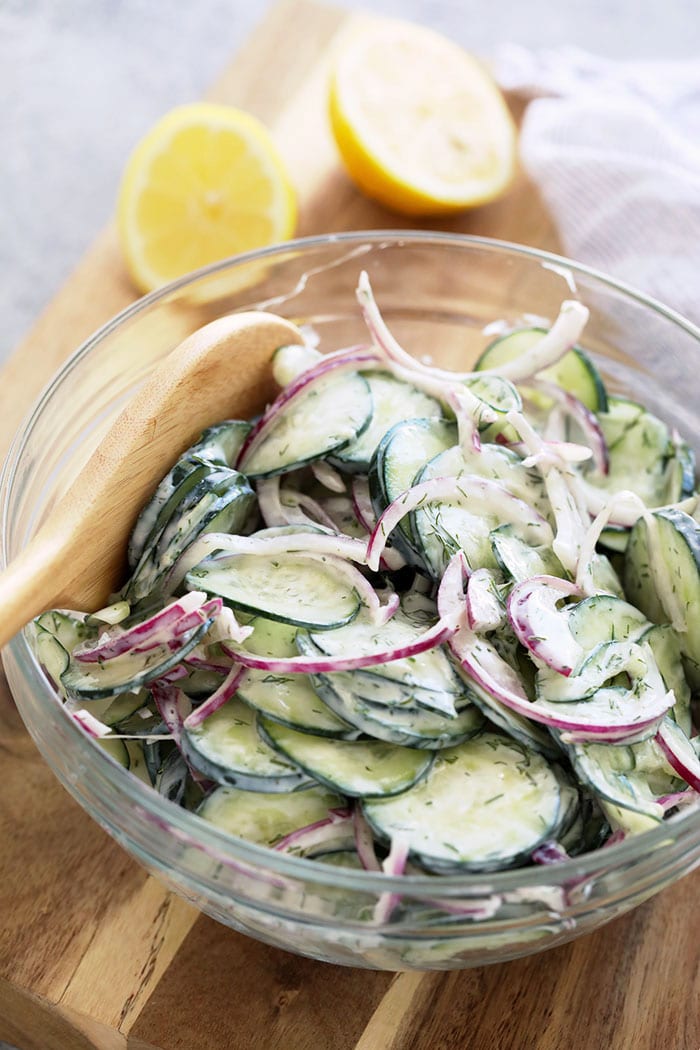 If you are looking for a healthy side salad for your next BBQ or a healthy salad for meal prep, look no further! This creamy cucumber salad is simple, flavorful, and delicious. Creamy cucumber salad in a bowl.