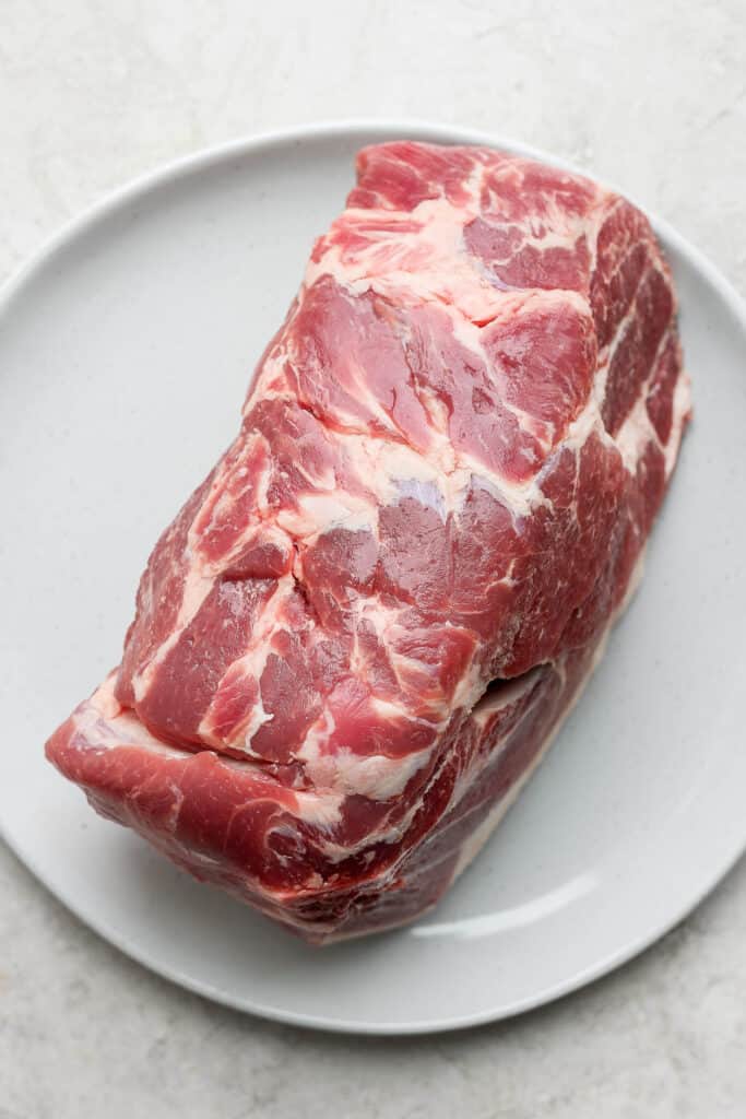 The best pork shoulder recipes are cooked low and slow. This slow roasted pork shoulder is slightly sweet and incredibly tender with crispy, crunchy edges. This is one of the best pork shoulder recipes of all time! pork shoulder on plate