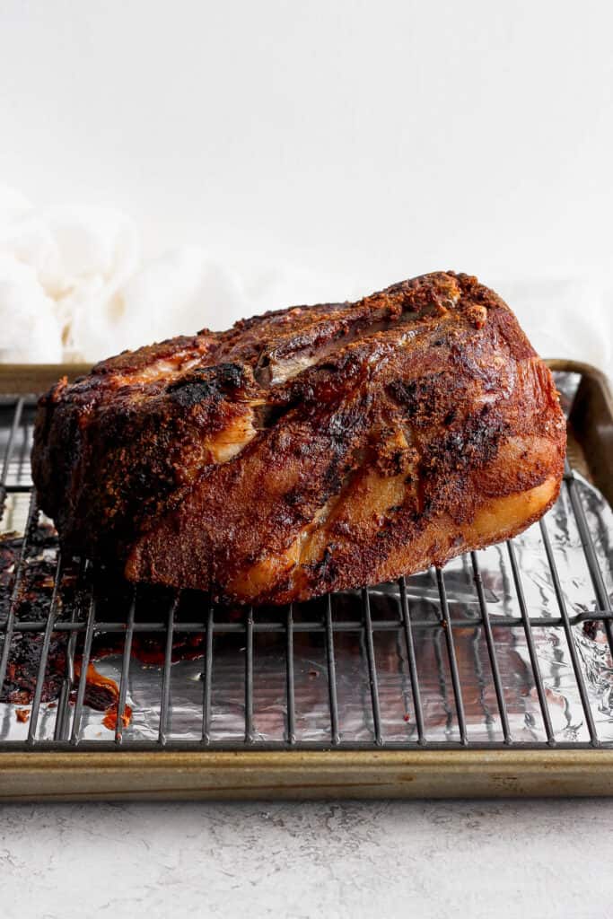 The best pork shoulder recipes are cooked low and slow. This slow roasted pork shoulder is slightly sweet and incredibly tender with crispy, crunchy edges. This is one of the best pork shoulder recipes of all time! slow cooked pork on wire rack