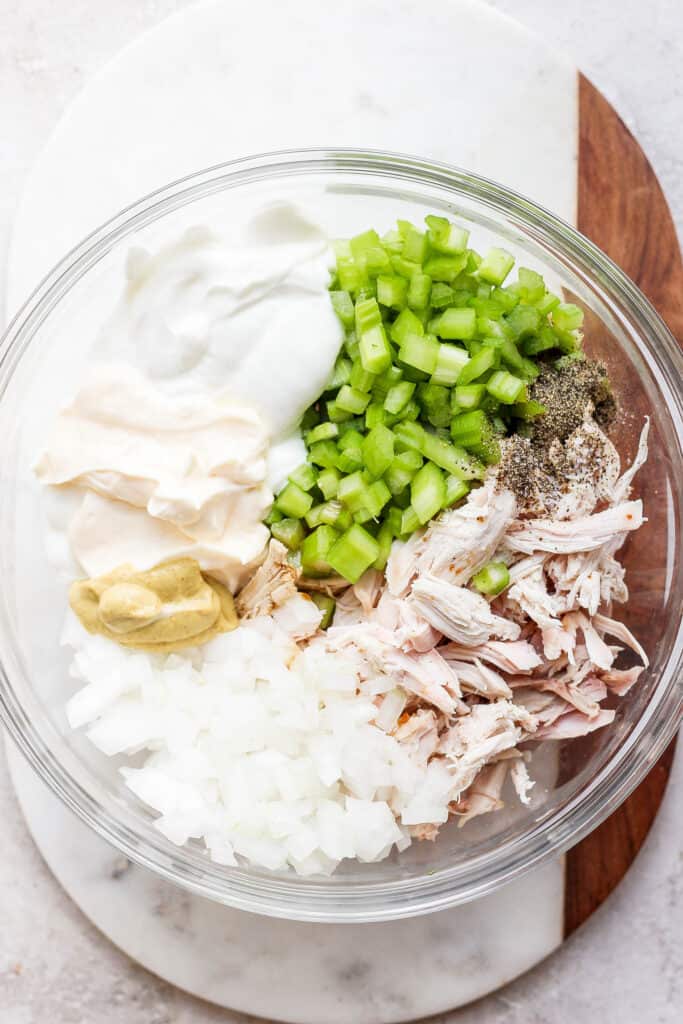 Got leftover smoked chicken? Make this super simple smoked chicken salad recipe for an easy way to re-purpose your leftovers! smoked chicken salad ingredients in bowl