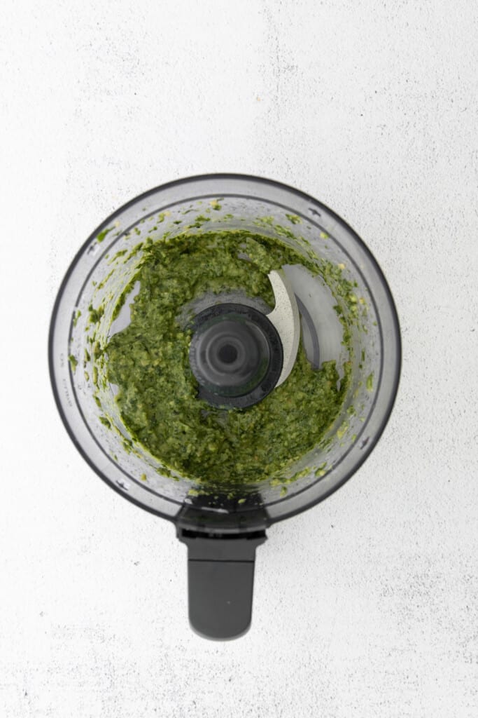 This basil pesto is made with simple ingredients of fresh basil, parmesan cheese, garlic, lemon juice, and olive oil. This pesto recipe is perfect for bread dipping and delicious tossed with pasta. pesto in food processor