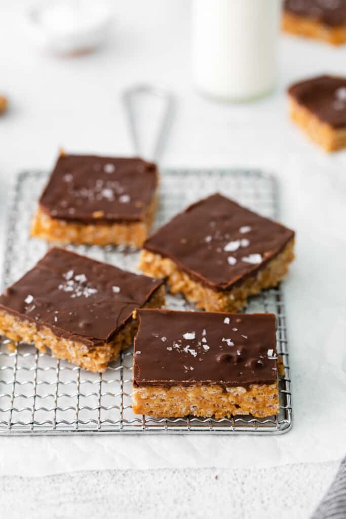 These healthy scotcheroos are made with all natural sugar, unsalted peanut butter, and coconut oil (no white sugar or corn syrup)! They are ready in no time and a great healthy spin on this classic dessert bar. healthy scotcheroos sliced and topped with flaked sea salt