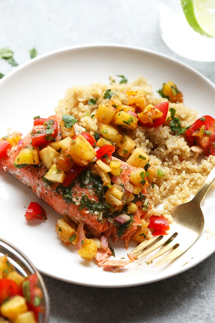 This grilled salmon in foil needs to be the star of your next summer bbq. This healthy meal is made in under 30 minutes on the grill and full of fresh flavor! Grilled salmon on a plate with pineapple salsa