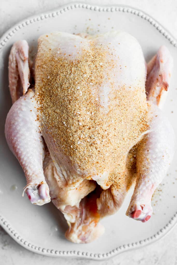 Smoked chicken dry rub on a whole chicken.