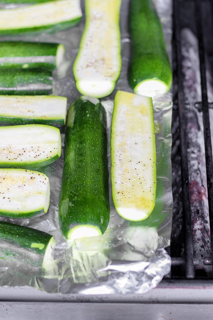 Turn on the grill and throw on some zucchini! Making grilled zucchini is easy and if you do it right you'll end up with grilled zucchini with a little crunch rather than a soggy mess. Grab the zucchini from your garden or the grocery store and get grilling! zucchini being grilled